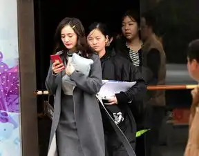 杨幂谈判官路透照曝光网瘾少女身披灰色大衣狂玩手机